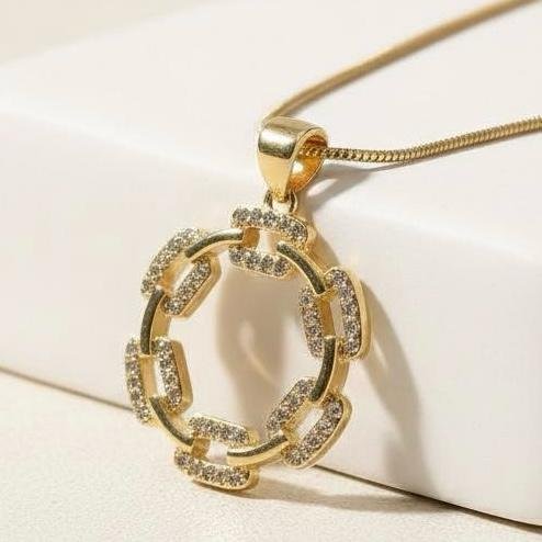 The I Speak Fluent Gucci necklace is a bold expression of style and sophistication. Featuring an open circular pendant crafted from interlinked, pavé crystal-encrusted links, it radiates modern elegance while paying homage to the iconic chain motifs of Italian couture. Suspended from a sleek gold-toned chain, this necklace is designed for those who carry luxury in their language and confidence in their presence. Perfect as a standalone statement or layered with other Bella Pia pieces, it embodies fashion as fluent as your voice.