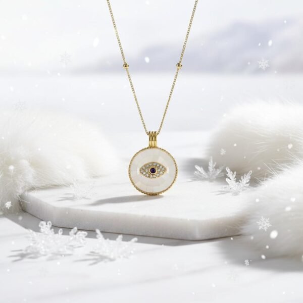 Protection in every glance. The Occhio Rosa and Occhio Bianco necklaces combine timeless tradition with modern elegance. Handcrafted with shimmering mother-of-pearl mosaics in soft blush pink or luminous white, each pendant features a sapphire-blue centerpiece surrounded by sparkling crystals — symbolizing the ancient talisman of the “evil eye.” Set in gold-plated detailing, these pendants are not only radiant accessories but also protective charms, believed to ward off negative energy while elevating any look.