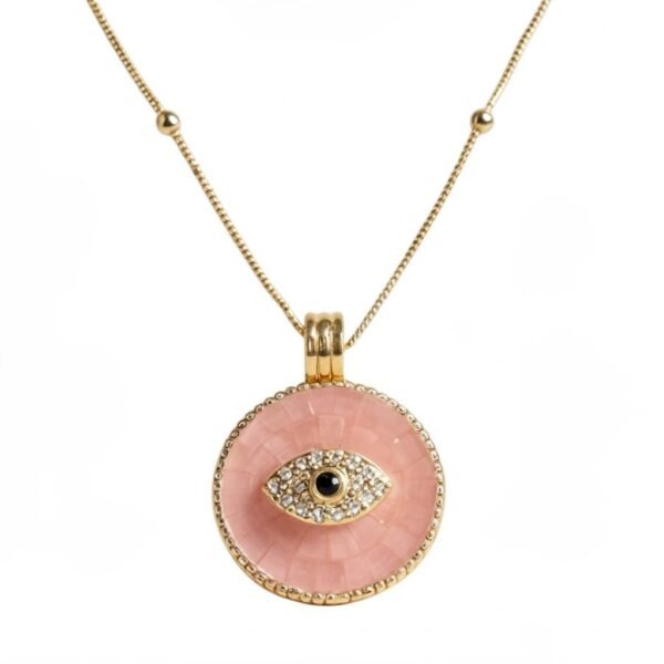 "Occhio" Protection in every glance. The Occhio Rosa and Occhio Bianco necklaces combine timeless tradition with modern elegance. Handcrafted with shimmering mother-of-pearl mosaics in soft blush pink or luminous white, each pendant features a sapphire-blue centerpiece surrounded by sparkling crystals, symbolizing the ancient talisman of the “evil eye.” Set in gold-plated detailing, these pendants are not only radiant accessories but also protective charms, believed to ward off negative energy while elevating any look. Designed to be worn close to the heart, the Occhio necklaces serve as both elegant accessories and modern talismans, believed to ward off negative energy while bringing balance, intention, and light to everyday style. Perfect worn alone or layered with other Bella Pia favorites, they are timeless pieces meant to protect, empower, and elevate every look.