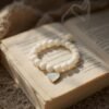 The Luna bracelet captures the serene beauty of the moon with luminous white beads, accented by a heart-shaped mother-of-pearl charm set in gold-plated detail. Symbolizing purity, love, and timeless grace, this piece is a reminder of the gentle light that guides us even in the darkest nights. Perfect on its own or paired with Rosalina for an ethereal, celestial stack.