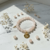 The Rosario a bracelet elevates the timeless elegance of rose quartz with not one, but two golden blooms. A bold gold-plated medallion with an embossed rose anchors the design, while a smaller, delicate rose charm rests gently off to the side. Together, they symbolize layered beauty, resilience, and love that grows in every direction. This thoughtful detail makes Rosario a statement of grace and femininity—perfect on its own or stacked with other Bella Pia favorites.