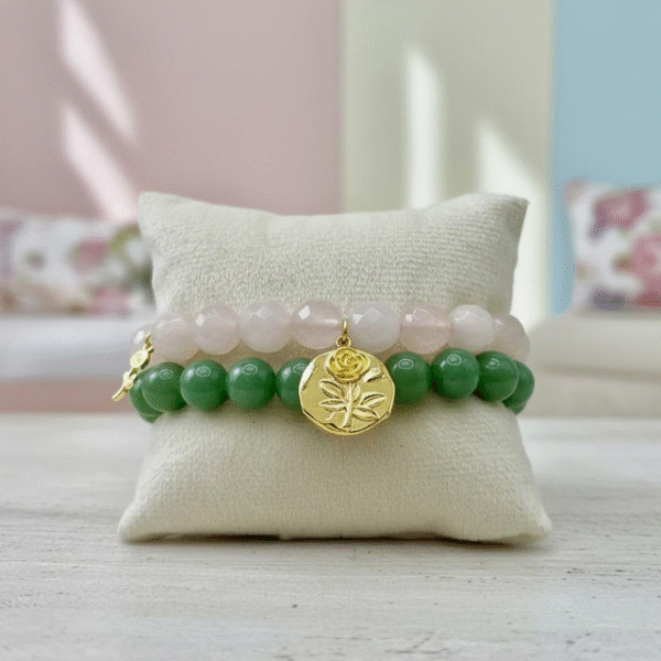 The Rosario a bracelet elevates the timeless elegance of rose quartz with not one, but two golden blooms. A bold gold-plated medallion with an embossed rose anchors the design, while a smaller, delicate rose charm rests gently off to the side. Together, they symbolize layered beauty, resilience, and love that grows in every direction. This thoughtful detail makes Rosario a statement of grace and femininity—perfect on its own or stacked with other Bella Pia favorites.