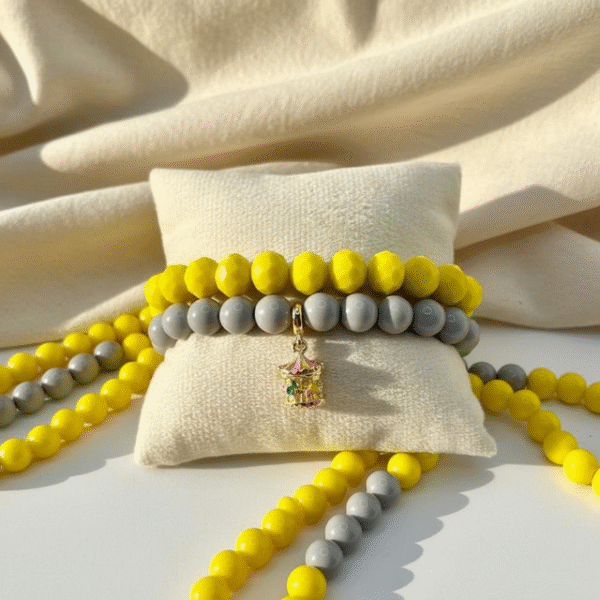 The Mama’s Carosello Bracelet captures the magic of cherished memories and the joy of motherhood. Designed with smooth gray beads for an elegant base, it features a hand-painted gold-plated carousel charm—carosello in Italian—that symbolizes love, nostalgia, and the playful spirit of family. A meaningful piece that makes a thoughtful gift for moms and anyone who treasures life’s sweetest moments.