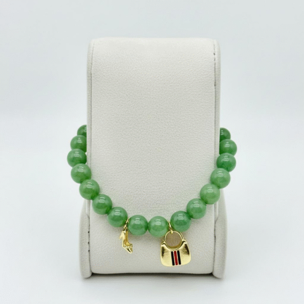 The I Speak Fluent Gucci Bracelet is for the woman who speaks the language of style fluently. Featuring sleek green aventurine beads paired with a playful gold-plated handbag and cystal shoe charm, this piece balances whimsy with high fashion. It’s a bracelet that turns everyday moments into runway moments—perfect for stacking, gifting, or wearing solo as a statement of confidence and charm.