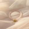 The Ella Bella Fiocco Bracelet is a delicate celebration of femininity and charm. Soft pink rose quartz beads, this piece features a dainty bow charm available in silver or gold-plated finishes. Perfect on its own or layered with other Ella Bella favorites, it’s a sweet symbol of grace, elegance, and playful sophistication. A bracelet that feels as special as the little moments it’s made to honor.