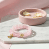 The Ella Bella Fiocco Bracelet is a delicate celebration of femininity and charm. Soft pink rose quartz beads, this piece features a dainty bow charm available in silver or gold-plated finishes. Perfect on its own or layered with other Ella Bella favorites, it’s a sweet symbol of grace, elegance, and playful sophistication. A bracelet that feels as special as the little moments it’s made to honor.