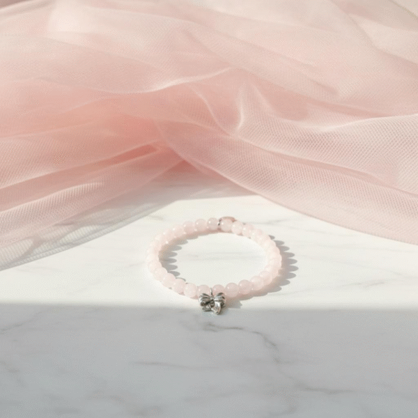 The Ella Bella Fiocco Bracelet is a delicate celebration of femininity and charm. Soft pink rose quartz beads, this piece features a dainty bow charm available in silver or gold-plated finishes. Perfect on its own or layered with other Ella Bella favorites, it’s a sweet symbol of grace, elegance, and playful sophistication. A bracelet that feels as special as the little moments it’s made to honor.