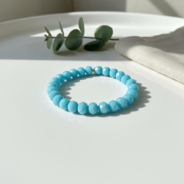 The Cielo Blu bracelet is a vibrant reflection of the Mediterranean sea and sky, crafted with crystal faceted azure beads that shimmer with every movement. Its refreshing hue brings a sense of calm and joy, making it a versatile piece perfect for layering or wearing on its own. A timeless accessory that radiates serenity and elegance.