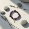 The Fede di Carolyn bracelet is a celebration of devotion, love, and lifelong friendship. Handcrafted with faceted amethyst stones, each bead carries calming and spiritual energy, symbolizing peace, clarity, and strength. The design is completed with three meaningful charms: A sparkling gold-plated cross framed with crystals, representing unwavering faith, a delicate light amethyst heart charm set in gold-plating, symbolizing pure love and compassion, and a gold-plated infinity symbol for eternity. This bracelet is a timeless reminder of unbreakable bonds and cherished connections.