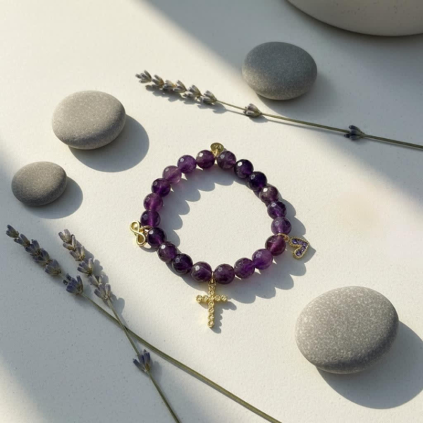 The Fede di Carolyn bracelet is a celebration of devotion, love, and lifelong friendship. Handcrafted with faceted amethyst stones, each bead carries calming and spiritual energy, symbolizing peace, clarity, and strength. The design is completed with three meaningful charms: A sparkling gold-plated cross framed with crystals, representing unwavering faith, a delicate light amethyst heart charm set in gold-plating, symbolizing pure love and compassion, and a gold-plated infinity symbol for eternity. This bracelet is a timeless reminder of unbreakable bonds and cherished connections.