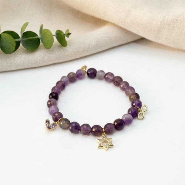 The Fede di Carolyn bracelet is a celebration of devotion, love, and lifelong friendship. Handcrafted with faceted amethyst stones, each bead carries calming and spiritual energy, symbolizing peace, clarity, and strength. The design is completed with three meaningful charms: A sparkling gold-plated cross framed with crystals, representing unwavering faith, a delicate light amethyst heart charm set in gold-plating, symbolizing pure love and compassion, and a gold-plated infinity symbol for eternity. This bracelet is a timeless reminder of unbreakable bonds and cherished connections.