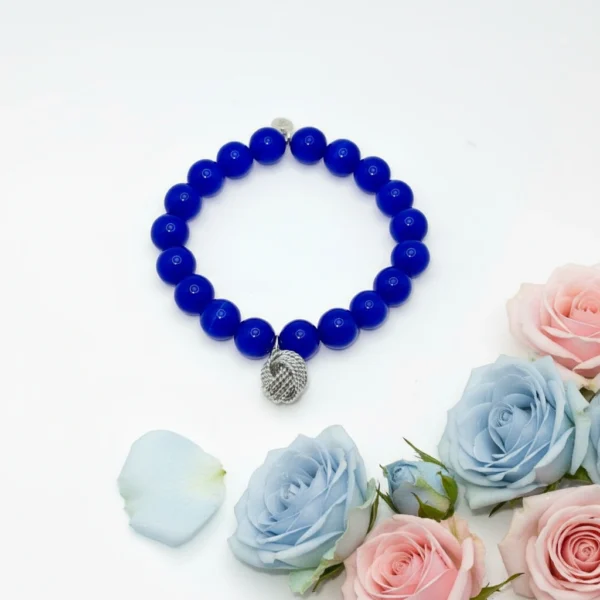 The Nodo D&G Bracelet is a heartfelt tribute to the unbreakable bond between mother and sons. Handcrafted with radiant sapphire-blue stones, it radiates strength, clarity, and devotion. At its center rests a beautifully detailed silver knot charm — a timeless symbol of connection, loyalty, and love that can never be undone. Whether worn as a daily reminder of cherished family ties or as a statement of elegance, Nodo D&G embodies both meaning and style. A piece that moves seamlessly from casual wear to evening elegance, it’s more than jewelry — it’s a story of family, heritage, and devotion