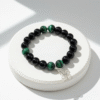 The Ali di Speranza bracelet is a symbol of resilience, renewal, and hope. Handcrafted with grounding black onyx and radiant green malachite beads, it is finished with a delicate silver butterfly charm — a timeless emblem of transformation and light. Each element is chosen to inspire strength through life’s challenges while celebrating the beauty of change. This bracelet is more than jewelry; it’s a gesture of compassion. A portion of the proceeds from every Ali di Speranza bracelet is donated to JAR of Hope, supporting research and awareness in the fight against Duchenne Muscular Dystrophy. Wear it as a reminder that every step forward is a flight toward hope.