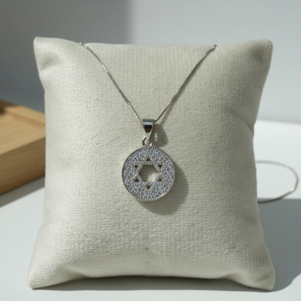 The Stella di Luce necklace embodies both beauty and meaning. Its circular pendant, delicately encrusted with sparkling crystals, features a Star of David cut-out at the center — a symbol of faith, protection, and unity. Crafted in sterling silver with a refined chain, this piece radiates elegance while honoring tradition. Versatile enough for everyday wear and sophisticated enough for cherished occasions, the Stella di Luce necklace is more than jewelry — it’s a timeless expression of light, love, and strength.