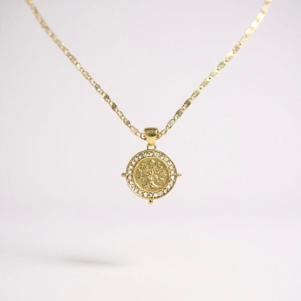 The Albero d’Oro Necklace embodies the eternal Tree of Life, a timeless symbol of growth, balance, and connection. Crafted in gold-plated elegance, the medallion features an intricately detailed tree framed with delicate crystal accents, catching the light with every movement. Perfect for layering or wearing solo, this piece carries a touch of heritage and a whisper of modern sophistication.