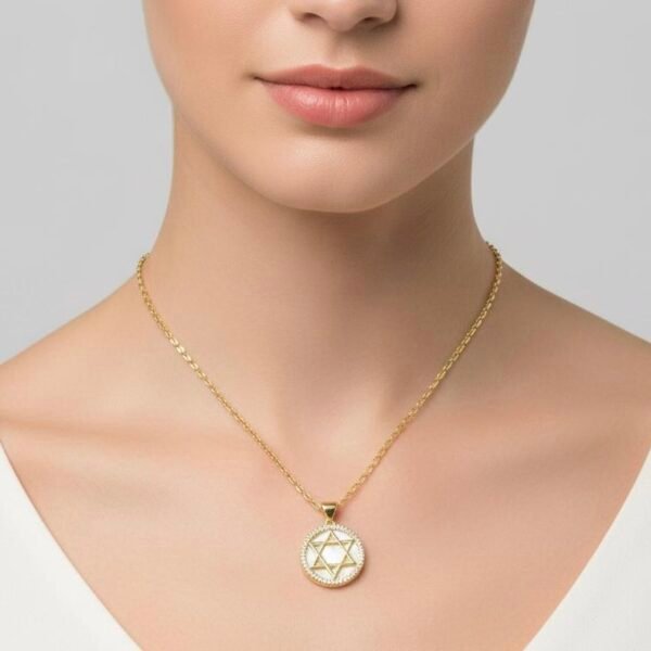 The Stella di Luna Necklace is a radiant tribute to the Star of David, crafted in luminous gold plating with a lustrous mother-of-pearl inlay. The six-pointed star — a timeless symbol of faith, protection, and divine balance — is encircled with a halo of sparkling crystals, reflecting moonlit brilliance. Designed to capture both elegance and meaning, this necklace celebrates heritage while exuding modern sophistication. Whether worn as a statement of devotion or a keepsake of tradition, it shines with enduring beauty.
