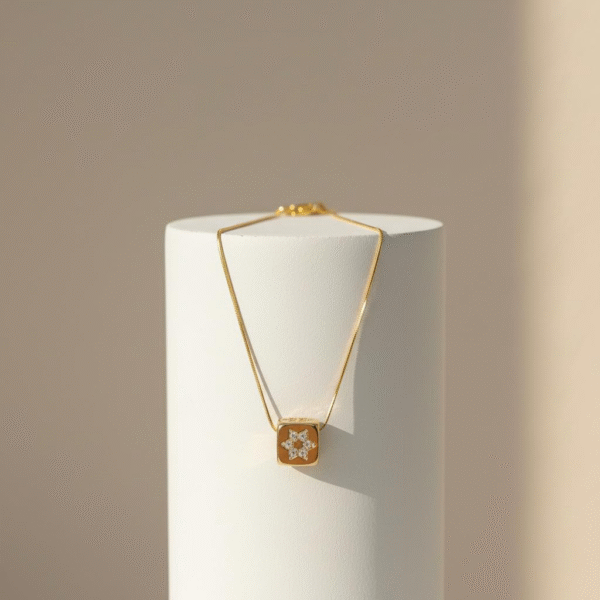 The Stella Cuba Necklace embodies the harmony of geometry and brilliance. A sculptural gold-plated cube frames a crystal-studded starburst, catching the light from every angle. Bold yet refined, this piece elevates any look with architectural elegance — whether worn as a solo statement or layered for a contemporary edge. Inspired by the cosmos, designed for the modern muse.