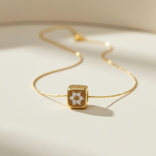 The Stella Cuba Necklace embodies the harmony of geometry and brilliance. A sculptural gold-plated cube frames a crystal-studded starburst, catching the light from every angle. Bold yet refined, this piece elevates any look with architectural elegance — whether worn as a solo statement or layered for a contemporary edge. Inspired by the cosmos, designed for the modern muse.