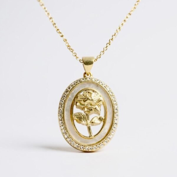The Luna Rosa Necklace is a romantic fusion of celestial glow and timeless beauty. Framed in an oval of luminous mother-of-pearl and shimmering crystals, it features a golden rose at its heart, plated in radiant gold for a touch of everlasting elegance. Symbolizing love, femininity, and grace, this piece transitions seamlessly from day to night, making it a treasured addition to any jewelry collection.