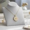 The Luce di Fede Necklace is a luminous expression of faith and elegance. Crafted with a radiant gold-plated setting, the round medallion showcases a central cross embraced by shimmering mother-of-pearl and encircled with a halo of sparkling crystals. This timeless design captures both spiritual devotion and refined sophistication, making it a versatile piece for daily wear or special occasions. A beautiful reminder of inner strength, guidance, and enduring light.