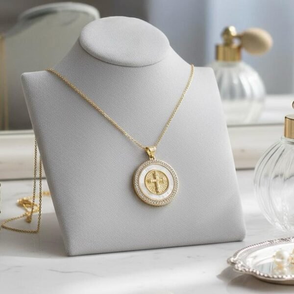 The Luce di Fede Necklace is a luminous expression of faith and elegance. Crafted with a radiant gold-plated setting, the round medallion showcases a central cross embraced by shimmering mother-of-pearl and encircled with a halo of sparkling crystals. This timeless design captures both spiritual devotion and refined sophistication, making it a versatile piece for daily wear or special occasions. A beautiful reminder of inner strength, guidance, and enduring light.