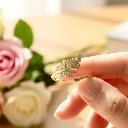 The Foglia Dorata Ring captures the delicate beauty of nature in a fashion-forward design. Crafted in gold-plated brass, this adjustable ring showcases a sparkling pavé crystal leaf that wraps gracefully around your finger. Its open band ensures a comfortable fit while adding a touch of modern sophistication. A perfect piece for layering or wearing solo, this ring embodies effortless glamour and everyday versatility. Whether worn casually or as a statement accessory, the Foglia Dorata Ring is a timeless expression of natural beauty elevated with radiant sparkle.