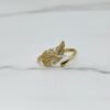 The Foglia Dorata Ring captures the delicate beauty of nature in a fashion-forward design. Crafted in gold-plated brass, this adjustable ring showcases a sparkling pavé crystal leaf that wraps gracefully around your finger. Its open band ensures a comfortable fit while adding a touch of modern sophistication. A perfect piece for layering or wearing solo, this ring embodies effortless glamour and everyday versatility. Whether worn casually or as a statement accessory, the Foglia Dorata Ring is a timeless expression of natural beauty elevated with radiant sparkle.