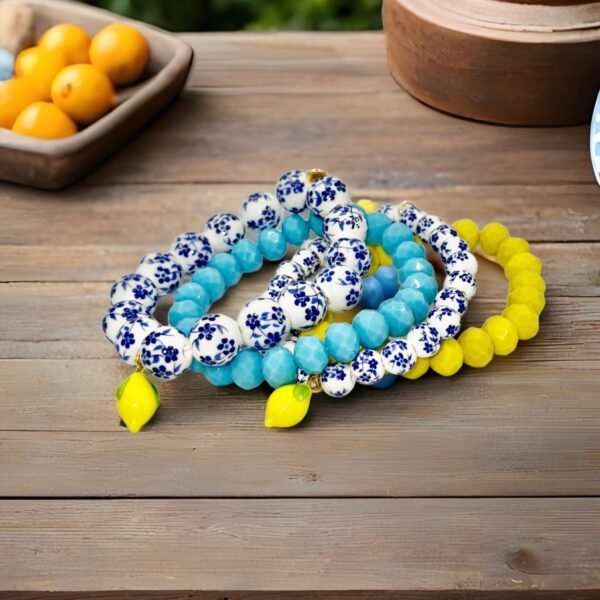Fresh Elegance, Italian Charm. Infused with the zest and sunshine of Italy, the Limoncello Bracelet captures the joyful spirit of the Amalfi Coast. Featuring hand-painted blue and white floral ceramic-style beads accented with a vibrant lemon charm, this piece embodies both playful elegance and timeless Italian charm. Perfect on its own or stacked for a bold Mediterranean statement, Limoncello adds a refreshing touch of la dolce vita to any look.