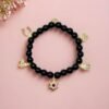 Step into protection and style with the Ginevra’s Amuleto Bracelet, a striking piece crafted with sleek black beads and adorned with radiant gold-plated charms. Featuring meaningful symbols—such as the cross, Star of David, heart, Hamsa hand, clover, and horseshoe—this bracelet celebrates spirituality, luck, and love all in one. Whether worn daily as a personal talisman or styled as a bold fashion statement, Ginevra’s Amuleto Bracelet is designed to keep positivity and elegance close to your wrist. A versatile piece for the woman who embraces both faith and fashion.