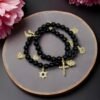 Step into protection and style with the Ginevra’s Amuleto Bracelet, a striking piece crafted with sleek black beads and adorned with radiant gold-plated charms. Featuring meaningful symbols—such as the cross, Star of David, heart, Hamsa hand, clover, and horseshoe—this bracelet celebrates spirituality, luck, and love all in one. Whether worn daily as a personal talisman or styled as a bold fashion statement, Ginevra’s Amuleto Bracelet is designed to keep positivity and elegance close to your wrist. A versatile piece for the woman who embraces both faith and fashion.