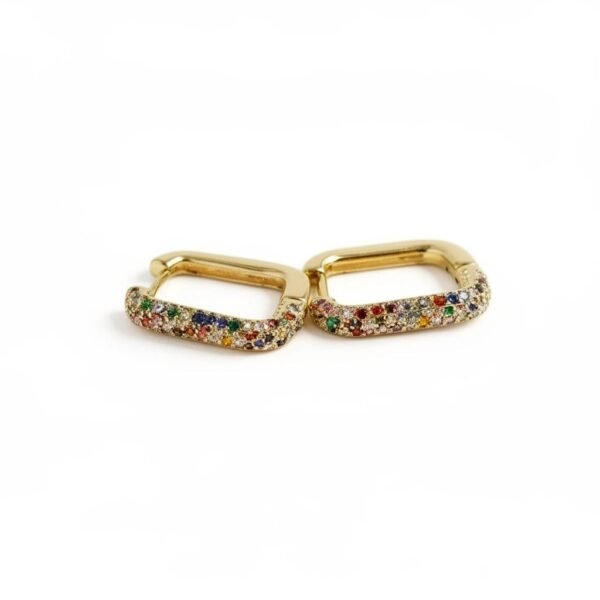 "Arcobaleno" Colors of faith, lights of hope. Bring a burst of color to your everyday style with the Arcobaleno Earrings, a celebration of vibrant beauty. Crafted in gold-plated brass, these rectangular hoops are adorned with multicolored crystal stones that sparkle with every movement. Perfect for both casual chic and evening glamour, they add a playful yet elegant touch to your look. Lightweight, versatile, and radiant, the Arcobaleno Earrings are the perfect accessory to brighten your day.