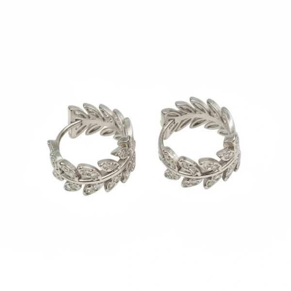 "Alloro" A timeless symbol of victory, honor and eternal Italian elegance. The Alloro Earrings are a refined expression of Italian heritage and timeless beauty. Inspired by the laurel wreath, an ancient symbol of victory and honor, these earrings are crafted with delicate leaf motifs and shimmering stones. Available in both gold-plated and silver finishes, they bring a graceful balance of classic design and modern sparkle. Perfect on their own or paired with the matching Alloro Ring, they embody elegance and strength for every occasion.