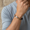 The Fede Forte Duo is a powerful two-piece men's bracelet set designed for the man who walks with faith and purpose. Handcrafted using natural brown lava stone, known for strength and grounding, and earth-toned olive wood beads that symbolize peace and resilience, this set carries meaning in every detail. At the heart of the design is a white howlite cross, a bold reminder of unwavering devotion and inner peace. Wear these bracelets together for a strong stacked look or separately for subtle everyday faith. Whether for prayer, reflection, or personal style, the Fede Forte Duo is a meaningful accessory for the modern believer.