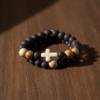 The Fede Forte Duo is a powerful two-piece men's bracelet set designed for the man who walks with faith and purpose. Handcrafted using natural brown lava stone, known for strength and grounding, and earth-toned olive wood beads that symbolize peace and resilience, this set carries meaning in every detail. At the heart of the design is a white howlite cross, a bold reminder of unwavering devotion and inner peace. Wear these bracelets together for a strong stacked look or separately for subtle everyday faith. Whether for prayer, reflection, or personal style, the Fede Forte Duo is a meaningful accessory for the modern believer.