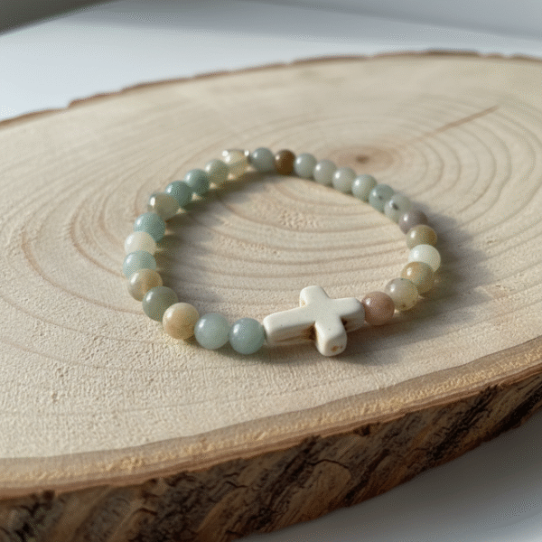 The Verde Serenità Bracelet is a calming symbol of faith and balance, handcrafted with soothing natural Amazonite stones. Known for their connection to emotional peace and inner harmony, these serene blue-green stones are beautifully paired with a white stone cross centerpiece—representing faith, guidance, and spiritual strength. Designed for both men and women, this bracelet embraces a minimalist earthy style that blends easily with everyday wear while holding a deeper meaning close to the heart. Whether worn alone or layered, it serves as a daily reminder of hope, purpose, and spiritual grounding.