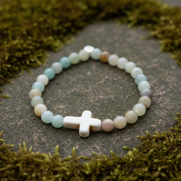 The Verde Serenità Bracelet is a calming symbol of faith and balance, handcrafted with soothing natural Amazonite stones. Known for their connection to emotional peace and inner harmony, these serene blue-green stones are beautifully paired with a white stone cross centerpiece—representing faith, guidance, and spiritual strength. Designed for both men and women, this bracelet embraces a minimalist earthy style that blends easily with everyday wear while holding a deeper meaning close to the heart. Whether worn alone or layered, it serves as a daily reminder of hope, purpose, and spiritual grounding.