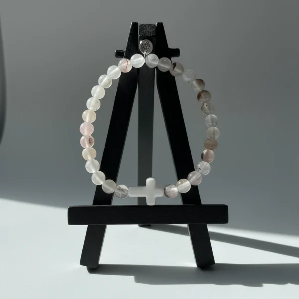 The Serenity Cross Bracelet is a minimalist expression of faith and inner peace. Handcrafted with smooth white agate gemstones, this bracelet embodies balance, grounding, and calm energy. At its center rests a sleek white cross bead, symbolizing guidance, hope, and divine protection. Its soft neutral palette makes it a beautiful and versatile accessory for both men and women, perfect for everyday wear, prayer, or meaningful gifting. Whether worn alone or stacked, it carries a message close to the heart—simple, spiritual, and sincere.