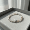 The Serenity Cross Bracelet is a minimalist expression of faith and inner peace. Handcrafted with smooth white agate gemstones, this bracelet embodies balance, grounding, and calm energy. At its center rests a sleek white cross bead, symbolizing guidance, hope, and divine protection. Its soft neutral palette makes it a beautiful and versatile accessory for both men and women, perfect for everyday wear, prayer, or meaningful gifting. Whether worn alone or stacked, it carries a message close to the heart—simple, spiritual, and sincere.