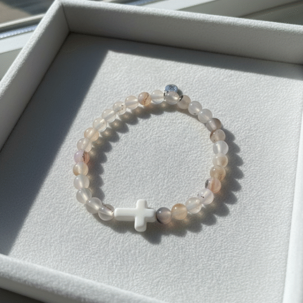 The Serenity Cross Bracelet is a minimalist expression of faith and inner peace. Handcrafted with smooth white agate gemstones, this bracelet embodies balance, grounding, and calm energy. At its center rests a sleek white cross bead, symbolizing guidance, hope, and divine protection. Its soft neutral palette makes it a beautiful and versatile accessory for both men and women, perfect for everyday wear, prayer, or meaningful gifting. Whether worn alone or stacked, it carries a message close to the heart—simple, spiritual, and sincere.