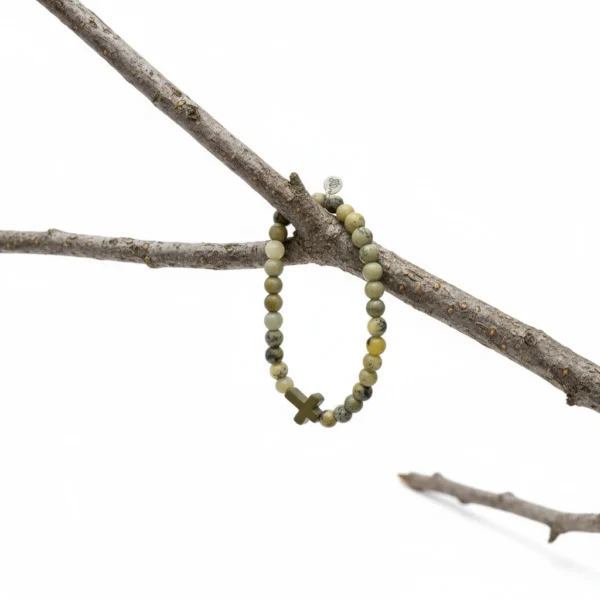 The Verde Pietà bracelet is rugged yet meaningful, designed for the man who carries strength and purpose in everything he does. Handcrafted with natural green jasper stone beads, this bracelet embodies grounding energy, courage, and resilience. At its center lies a matte green cross stone, a bold symbol of faith, balance, and protection. Each bead reflects earthy character—from forest tones to deep olive greens—making this bracelet effortlessly wearable for everyday style or layered with your favorite accessories. Built on a durable stretch cord for comfort and a custom fit, Verde Pietà is a tribute to quiet strength, inner peace, and unwavering beliefs.