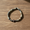 Inspired by the quiet strength of nature, the Terra Fide Bracelet blends earthy tones with spiritual meaning. Handcrafted with natural African Turquoise Jasper—known as the “Stone of Evolution”—this bracelet encourages positive transformation, balance, and inner growth. At its center rests a matte stone cross, symbolizing unshakable faith and guidance through life’s journey. Designed for both men and women, Terra Fide is a minimalist piece with major purpose. Whether worn alone for a refined everyday look or stacked with other bracelets, it’s a powerful reminder to stay grounded in faith and walk with purpose.