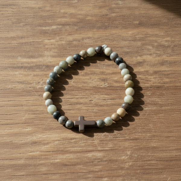 Inspired by the quiet strength of nature, the Terra Fide Bracelet blends earthy tones with spiritual meaning. Handcrafted with natural African Turquoise Jasper—known as the “Stone of Evolution”—this bracelet encourages positive transformation, balance, and inner growth. At its center rests a matte stone cross, symbolizing unshakable faith and guidance through life’s journey. Designed for both men and women, Terra Fide is a minimalist piece with major purpose. Whether worn alone for a refined everyday look or stacked with other bracelets, it’s a powerful reminder to stay grounded in faith and walk with purpose.