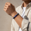 Discover effortless protection with the Azzuro Guard Bracelet—a modern take on ancient symbolism. Handcrafted with deep sapphire-blue sodalite stones, this bracelet represents clarity, intuition, and emotional balance. At its heart is the striking blue evil eye bead, a timeless symbol believed to shield against negativity and invite peace and good fortune. Versatile and powerful, this unisex bracelet transitions seamlessly from casual weekends to everyday wear. Whether worn alone or stacked, it’s a bold reminder to move through life with confidence and purpose.