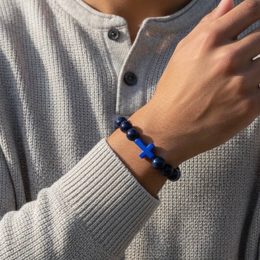 The Croce Azzurra bracelet blends bold faith with modern masculinity. Crafted with deep navy-blue natural stone beads and anchored by a striking azzurro (blue) cross, this piece carries purpose and power. The color blue symbolizes wisdom, protection, and confidence—making it more than just a bracelet, but a reflection of inner strength and belief. Designed for everyday wear, it elevates casual looks and pairs effortlessly with a watch or layered pieces. Whether you're stepping into the office, the gym, or a night out, Croce Azzurra keeps your faith close and your style sharp.