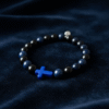 The Croce Azzurra bracelet blends bold faith with modern masculinity. Crafted with deep navy-blue natural stone beads and anchored by a striking azzurro (blue) cross, this piece carries purpose and power. The color blue symbolizes wisdom, protection, and confidence—making it more than just a bracelet, but a reflection of inner strength and belief. Designed for everyday wear, it elevates casual looks and pairs effortlessly with a watch or layered pieces. Whether you're stepping into the office, the gym, or a night out, Croce Azzurra keeps your faith close and your style sharp.