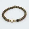 Grounded in natural beauty and spiritual meaning, the Croce Terra Bracelet blends earthy tones with a timeless symbol of faith. Handcrafted with natural jasper gemstone beads, each stone reflects the rugged beauty of nature and carries a grounding energy that inspires balance, courage, and calm. The bracelet is centered with a handcrafted white cross bead—an elegant reminder of faith and purpose. Designed for everyday wear, Croce Terra offers a minimalist style that pairs effortlessly with any look—casual, professional, or spiritual. Made with a comfortable stretch design to fit most wrists, it's perfect as a personal keepsake or a thoughtful gift of meaningful style.