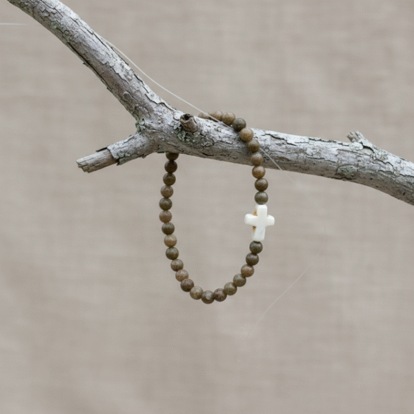Grounded in natural beauty and spiritual meaning, the Croce Terra Bracelet blends earthy tones with a timeless symbol of faith. Handcrafted with natural jasper gemstone beads, each stone reflects the rugged beauty of nature and carries a grounding energy that inspires balance, courage, and calm. The bracelet is centered with a handcrafted white cross bead—an elegant reminder of faith and purpose. Designed for everyday wear, Croce Terra offers a minimalist style that pairs effortlessly with any look—casual, professional, or spiritual. Made with a comfortable stretch design to fit most wrists, it's perfect as a personal keepsake or a thoughtful gift of meaningful style.