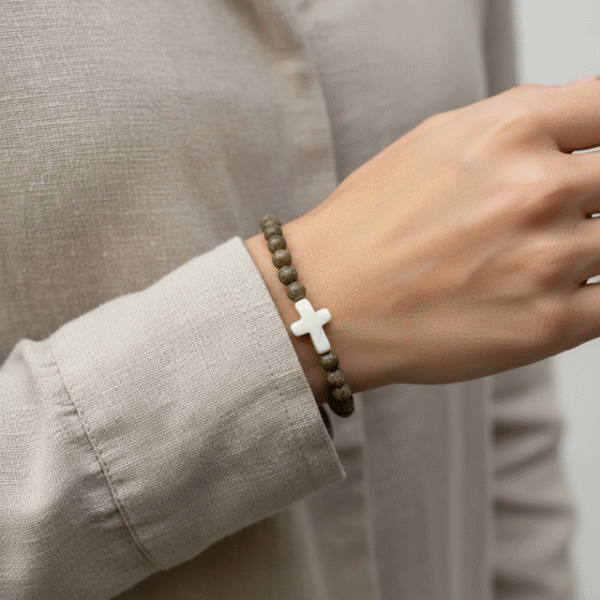 Grounded in natural beauty and spiritual meaning, the Croce Terra Bracelet blends earthy tones with a timeless symbol of faith. Handcrafted with natural jasper gemstone beads, each stone reflects the rugged beauty of nature and carries a grounding energy that inspires balance, courage, and calm. The bracelet is centered with a handcrafted white cross bead—an elegant reminder of faith and purpose. Designed for everyday wear, Croce Terra offers a minimalist style that pairs effortlessly with any look—casual, professional, or spiritual. Made with a comfortable stretch design to fit most wrists, it's perfect as a personal keepsake or a thoughtful gift of meaningful style.