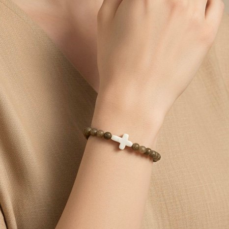 Grounded in natural beauty and spiritual meaning, the Croce Terra Bracelet blends earthy tones with a timeless symbol of faith. Handcrafted with natural jasper gemstone beads, each stone reflects the rugged beauty of nature and carries a grounding energy that inspires balance, courage, and calm. The bracelet is centered with a handcrafted white cross bead—an elegant reminder of faith and purpose. Designed for everyday wear, Croce Terra offers a minimalist style that pairs effortlessly with any look—casual, professional, or spiritual. Made with a comfortable stretch design to fit most wrists, it's perfect as a personal keepsake or a thoughtful gift of meaningful style.