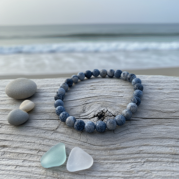 Inspired by the quiet power of the ocean after dusk, the Mare Notturno bracelet embodies depth, courage, and inner balance. Handcrafted with natural blue-grey dragon vein agate stones, each bead carries unique marbled patterns reminiscent of moonlit waves. Designed for the modern man who finds strength in stillness, this bracelet is both rugged and refined—perfect for everyday wear or layered with your favorite accessories.